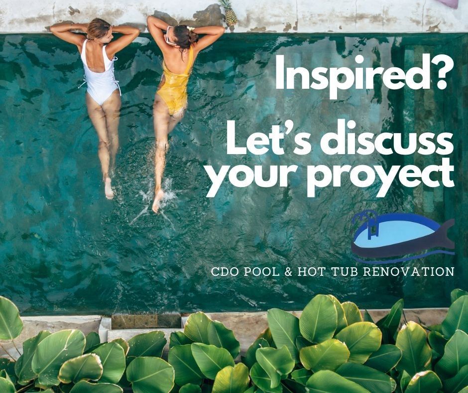 Two women are laying on top of a swimming pool.