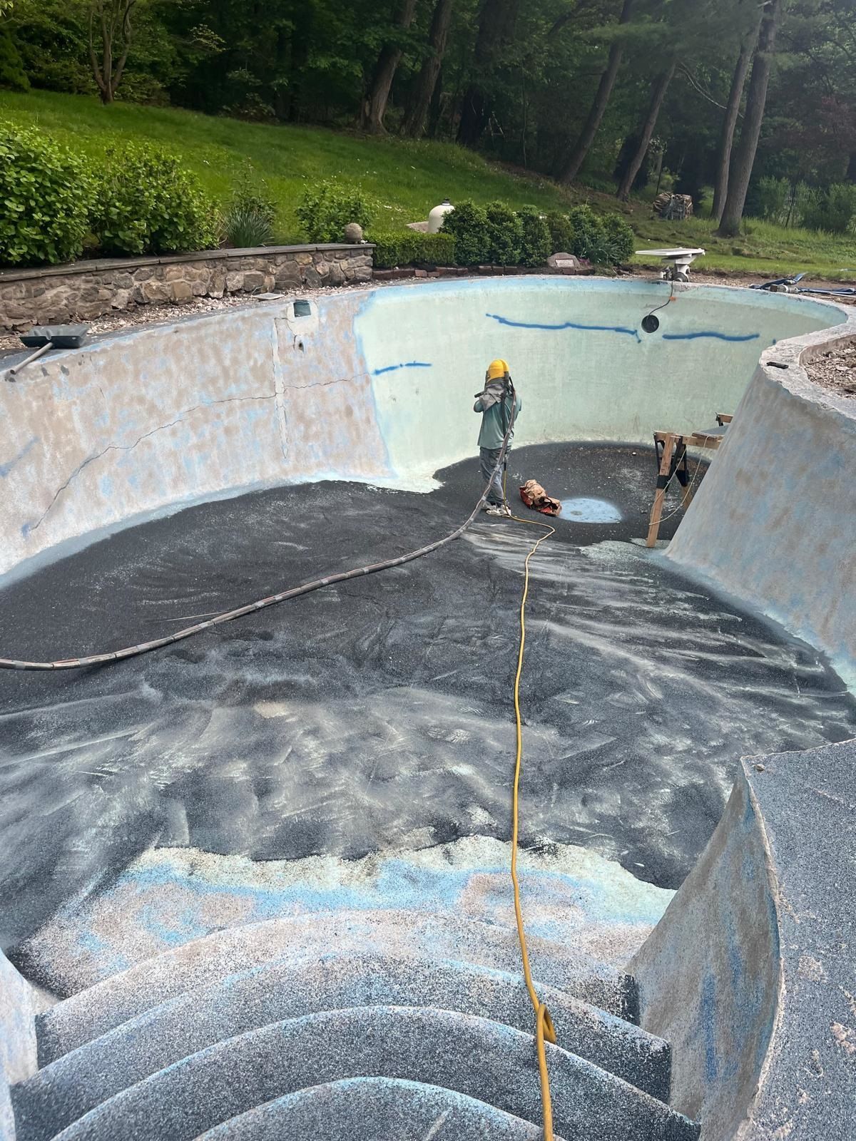A man is standing in the middle of a swimming pool.