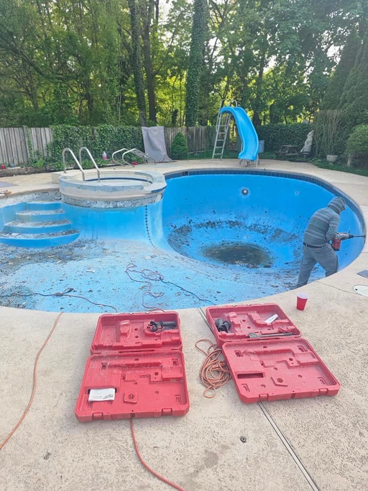 A man is working on a swimming pool next to a red toolbox.
