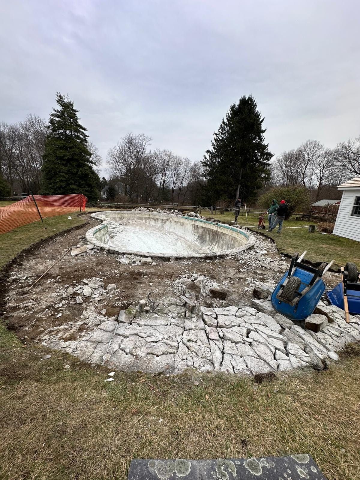 A swimming pool is being remodeled in a backyard.