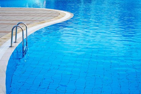 A swimming pool with a staircase leading into it.