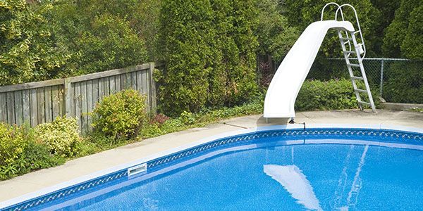 There is a diving board in the middle of the pool.