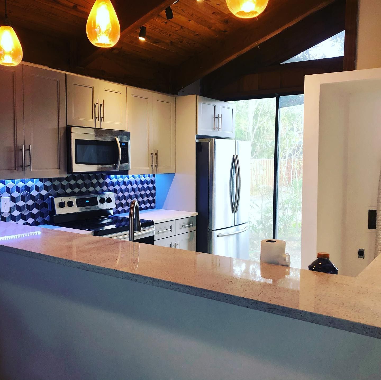 A kitchen with stainless steel appliances and white cabinets