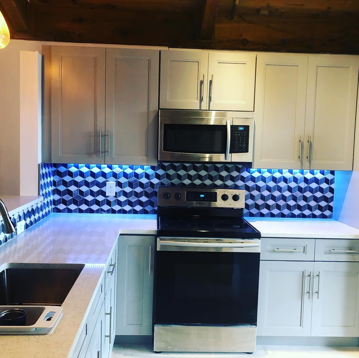 A kitchen with stainless steel appliances and white cabinets