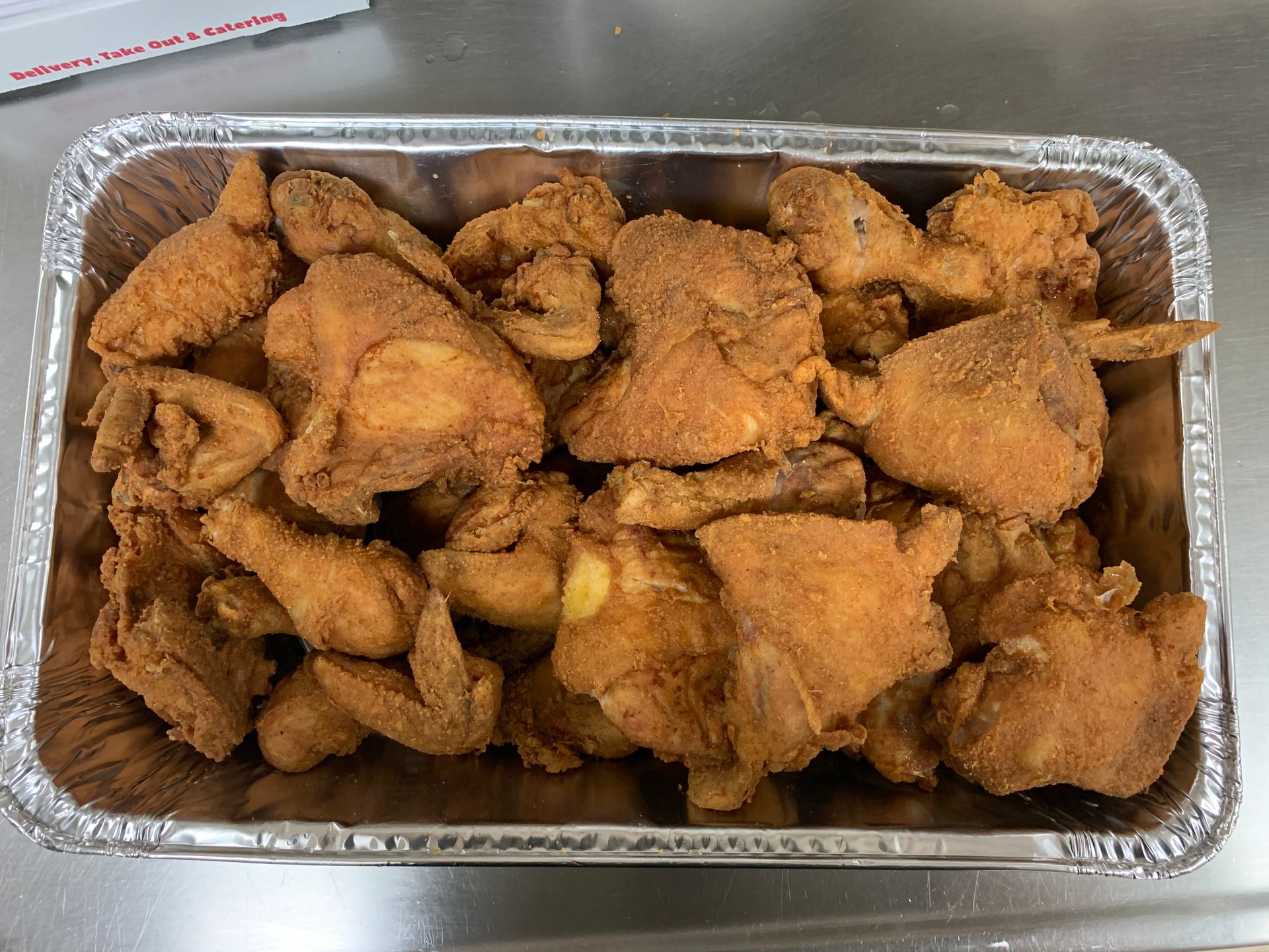 A tray of fried chicken is sitting on a table.