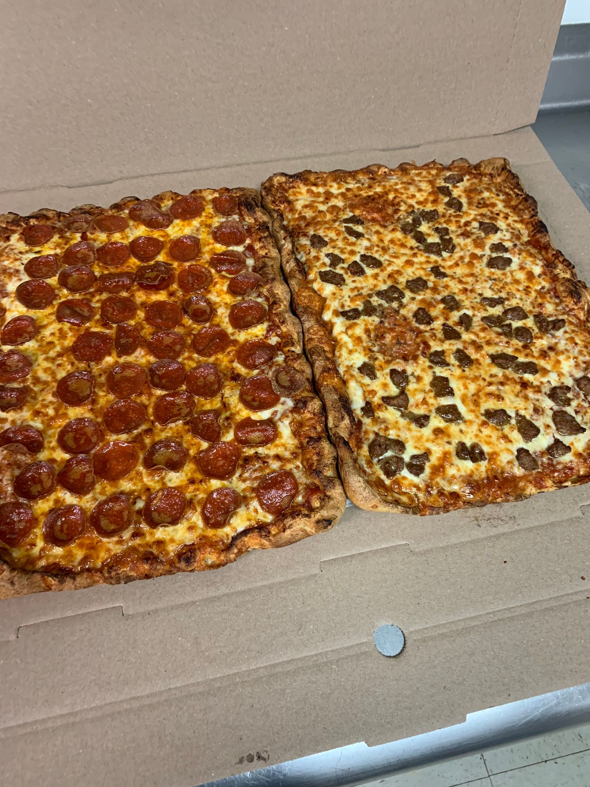 Two pizzas in a box one pepperoni and one cheese