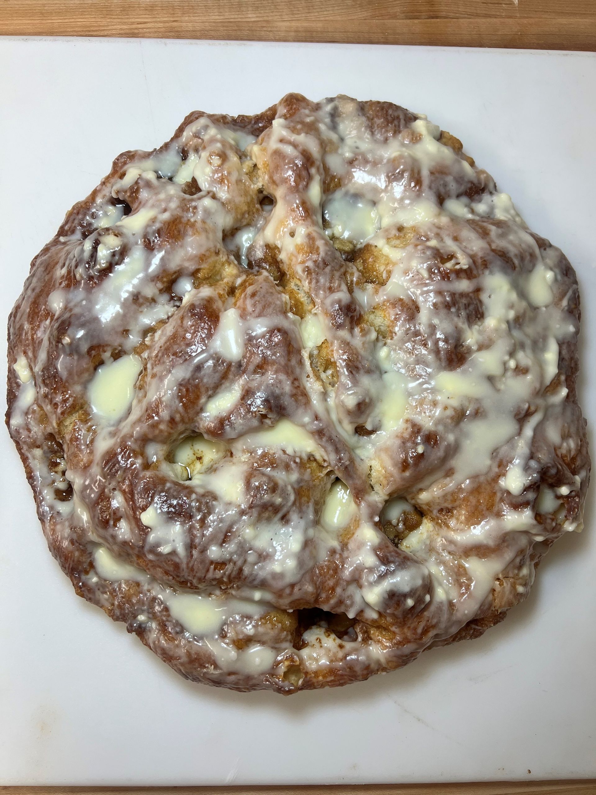 A close up of a cinnamon roll on a cutting board