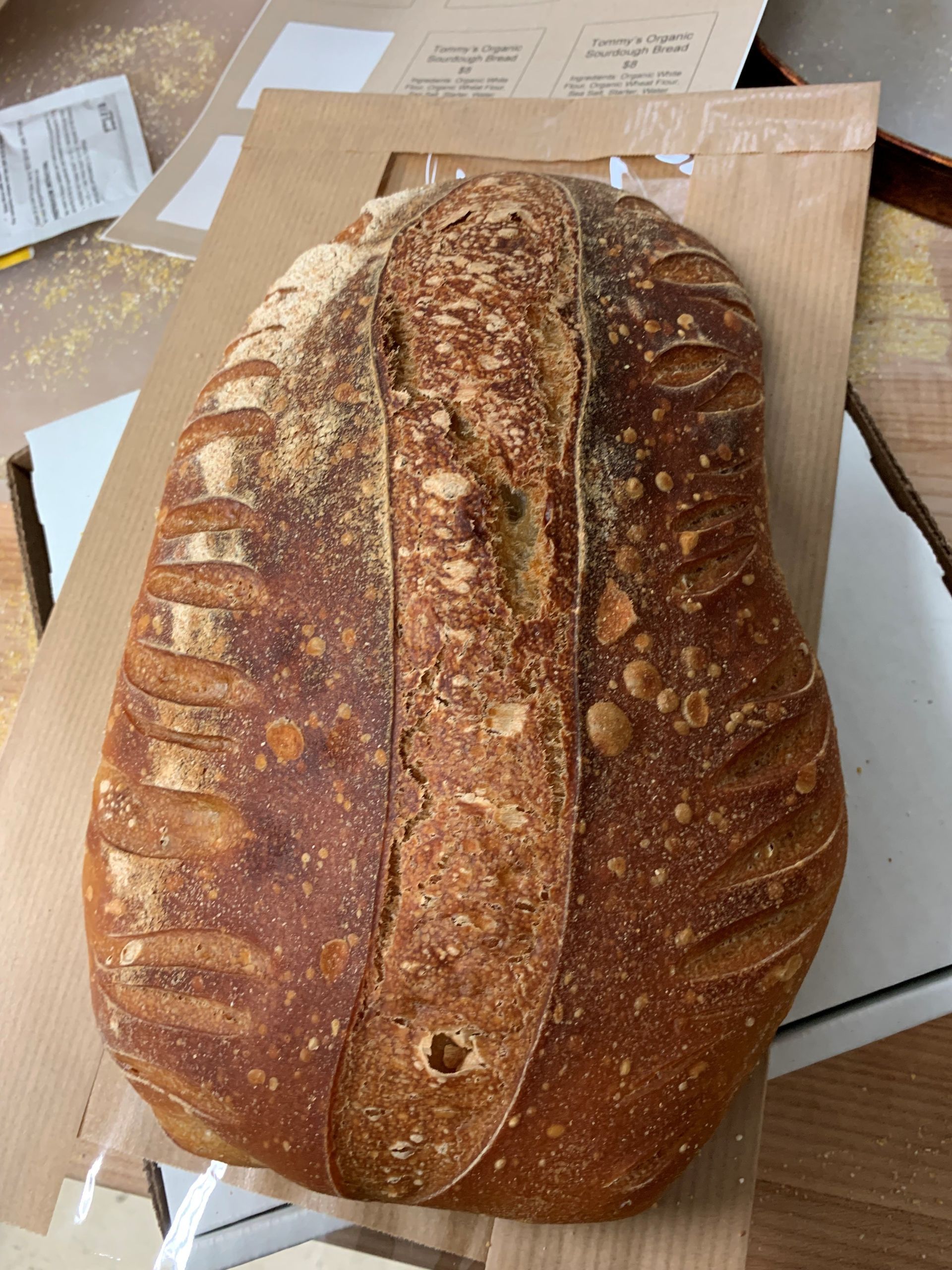 A loaf of bread is sitting on top of a cardboard box.