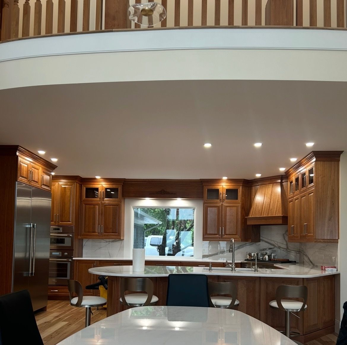 A kitchen with stainless steel appliances and wooden cabinets