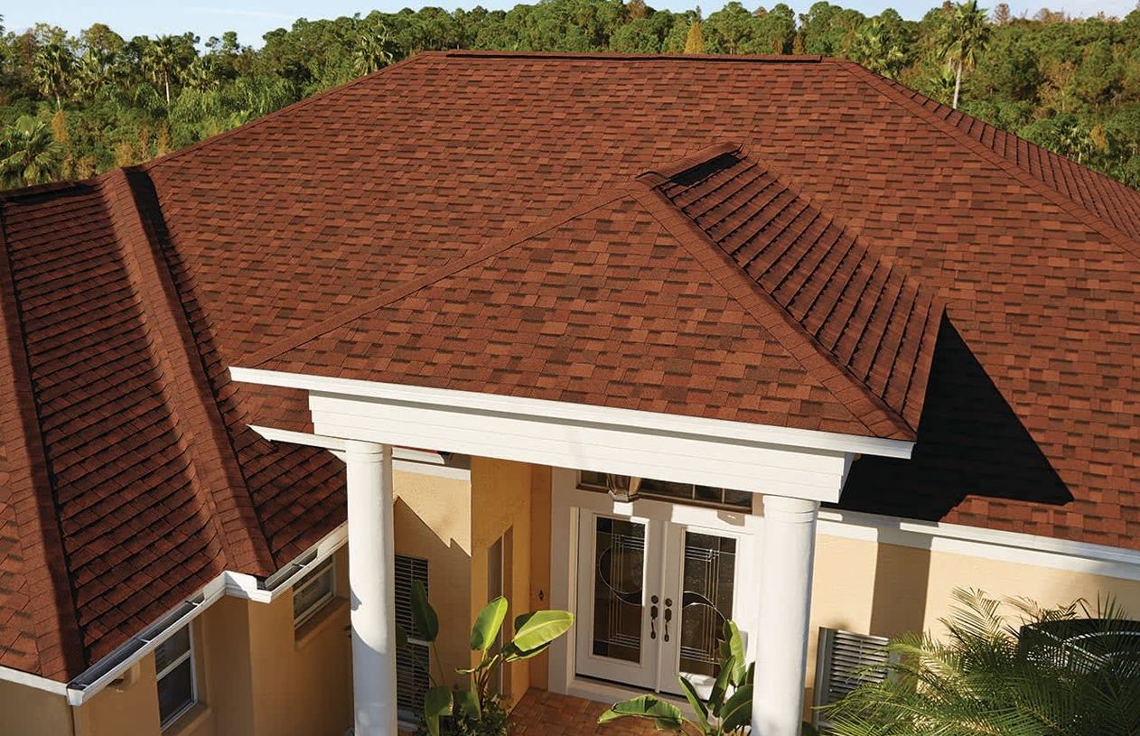 An aerial view of a house with a red roof