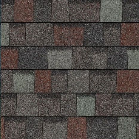A close up of a roof with different colored shingles.