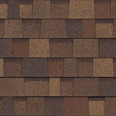 A close up of a roof with brown shingles