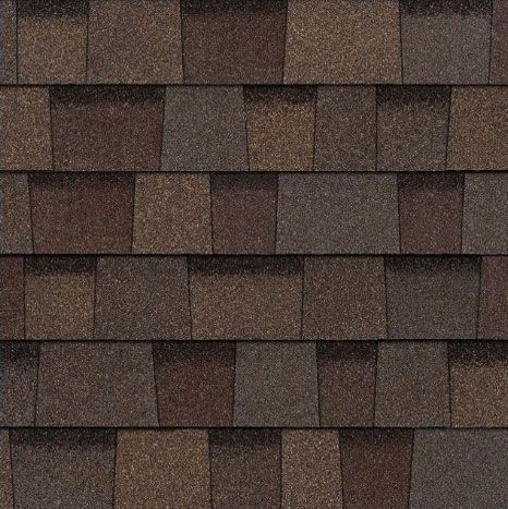 A close up of a row of brown shingles on a roof.