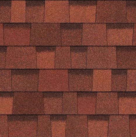 A close up of a row of red shingles on a roof.
