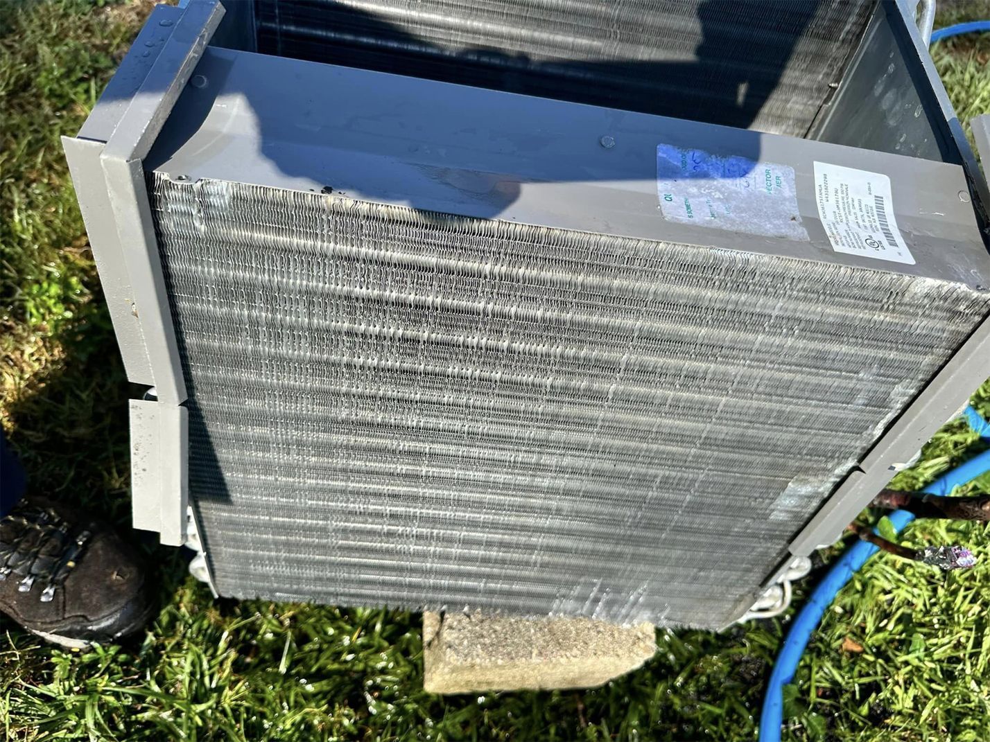A close up of a radiator sitting on top of a lush green field.