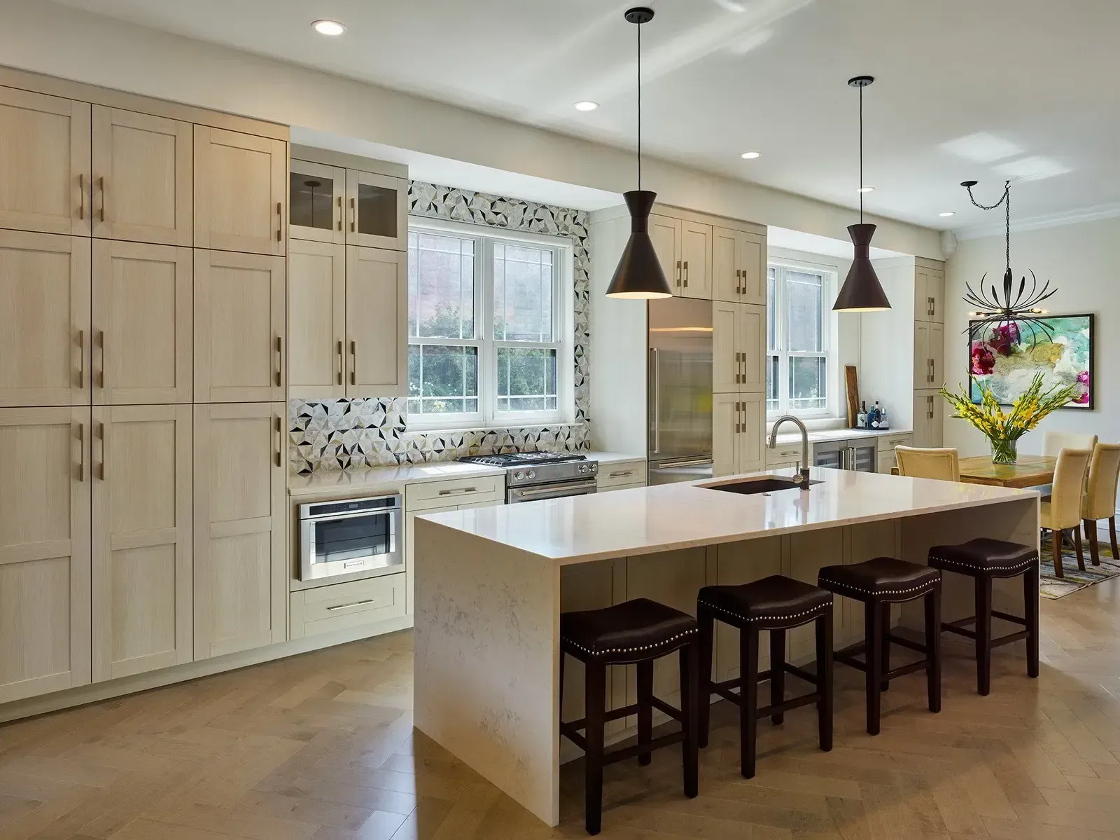 A kitchen with a large island and stools