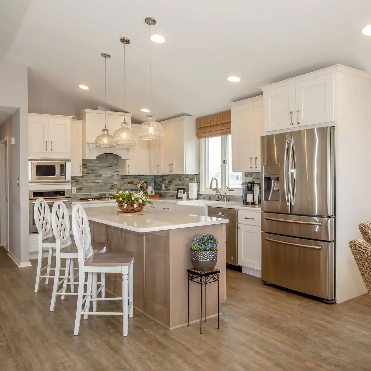 A kitchen with stainless steel appliances and white cabinets
