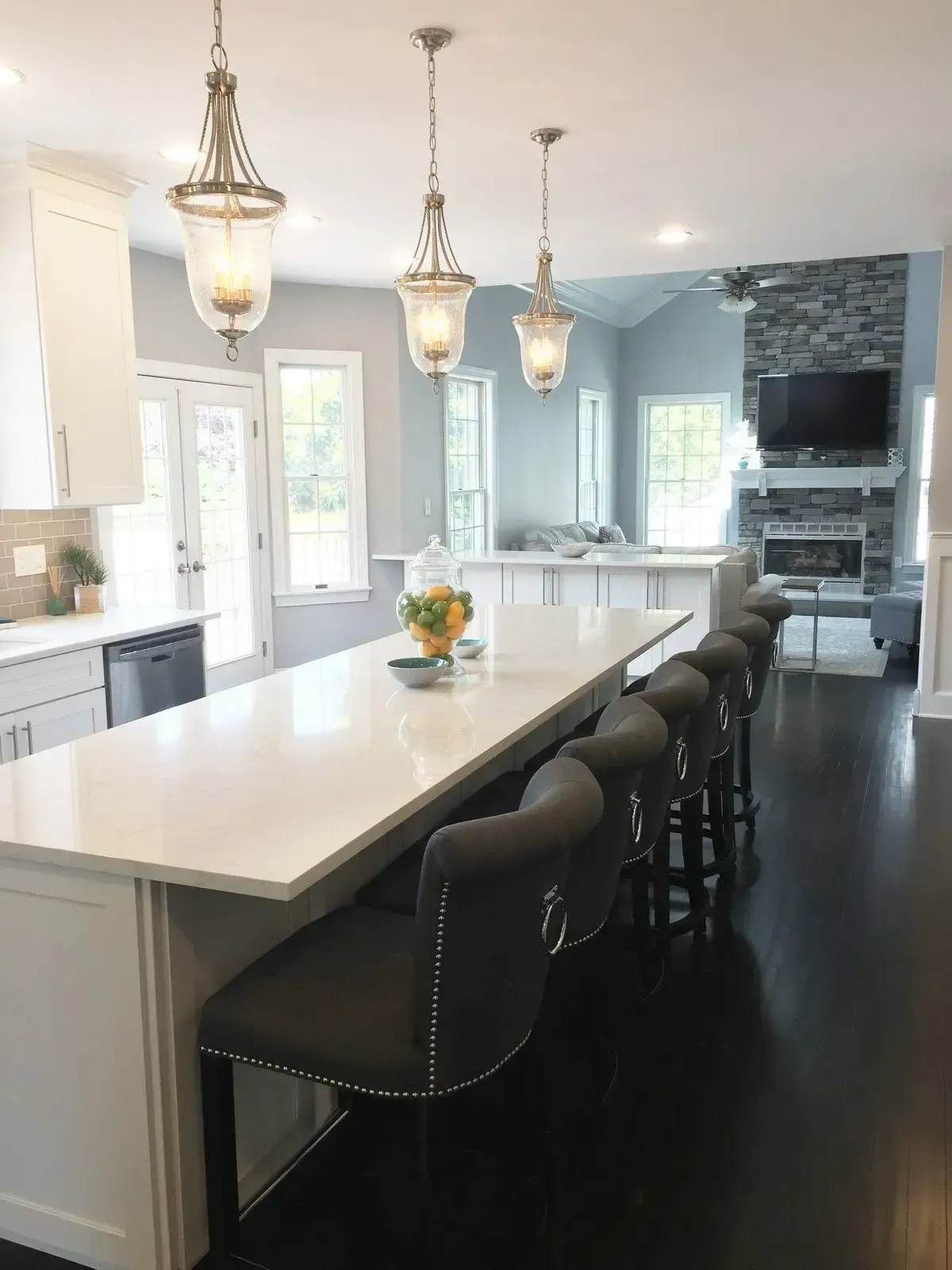 A kitchen with a large island and stools