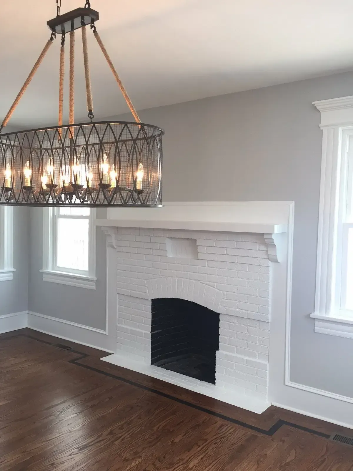 A living room with a fireplace and a chandelier
