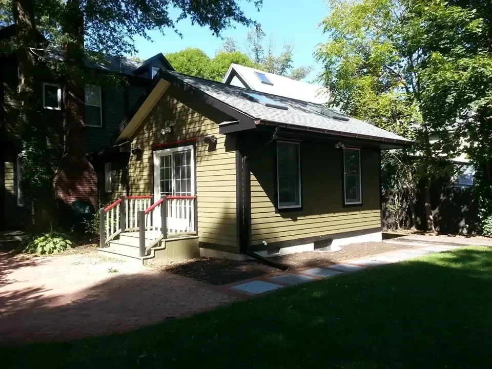 A small house with a roof that has solar panels on it