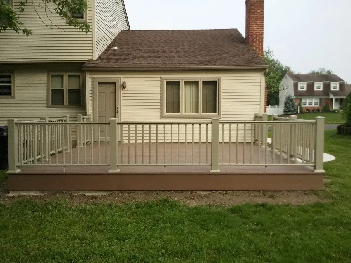 A small house with a deck in front of it