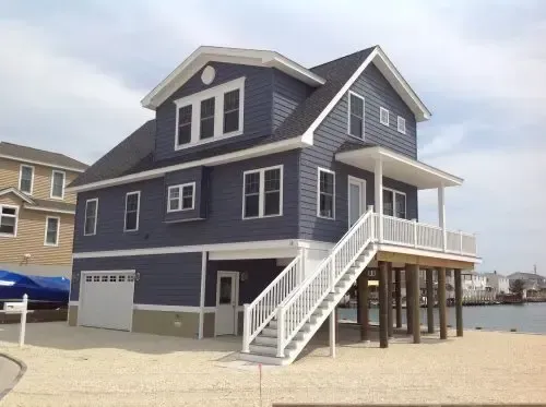 A large blue house with stairs leading up to it