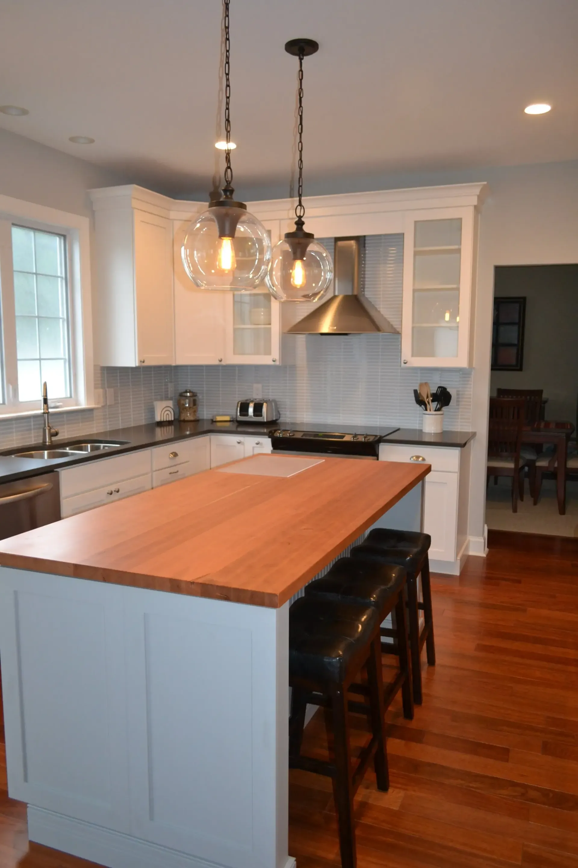 A kitchen with a large island and stools