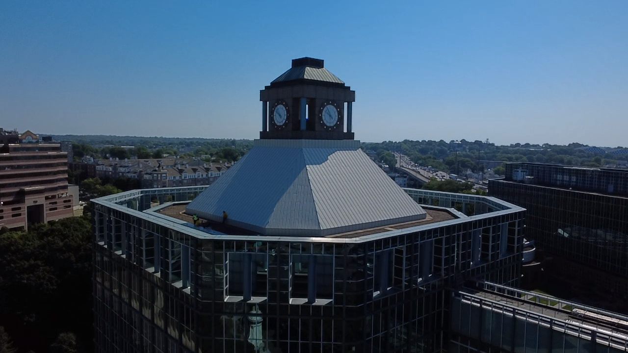 Historic building with a white roof and cupola, seen from above in a cityscape