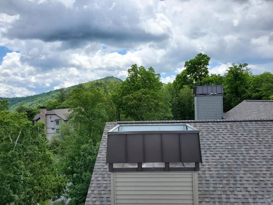 The roof of a house with a swimming pool on top of it.