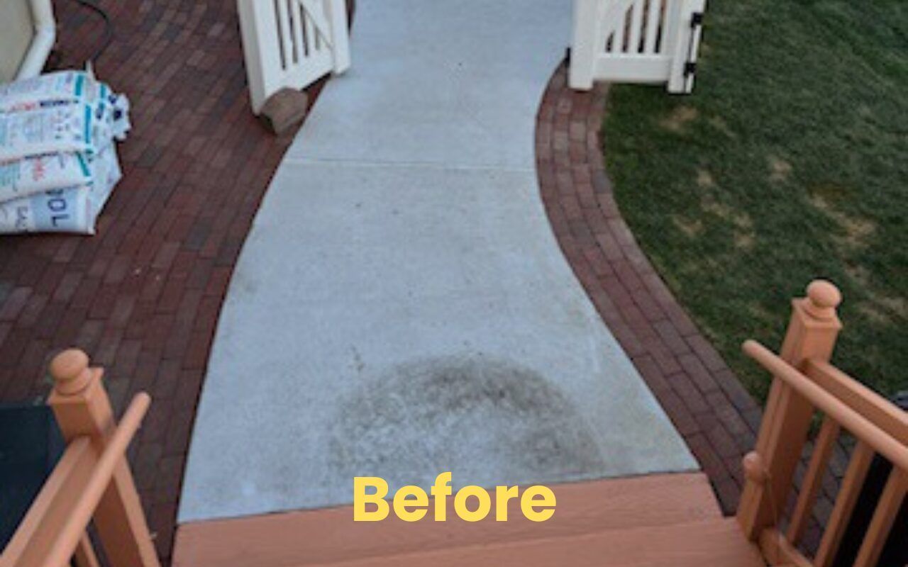 Brick walkway before cleaning with a dirty gray stain in the center and yellow “Before” text.