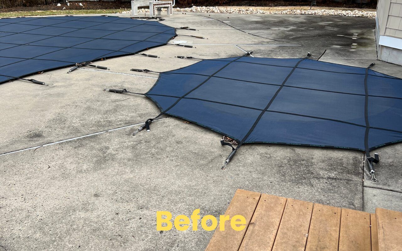 Concrete patio with blue rubber paver mats and a “Before” label on the bottom.