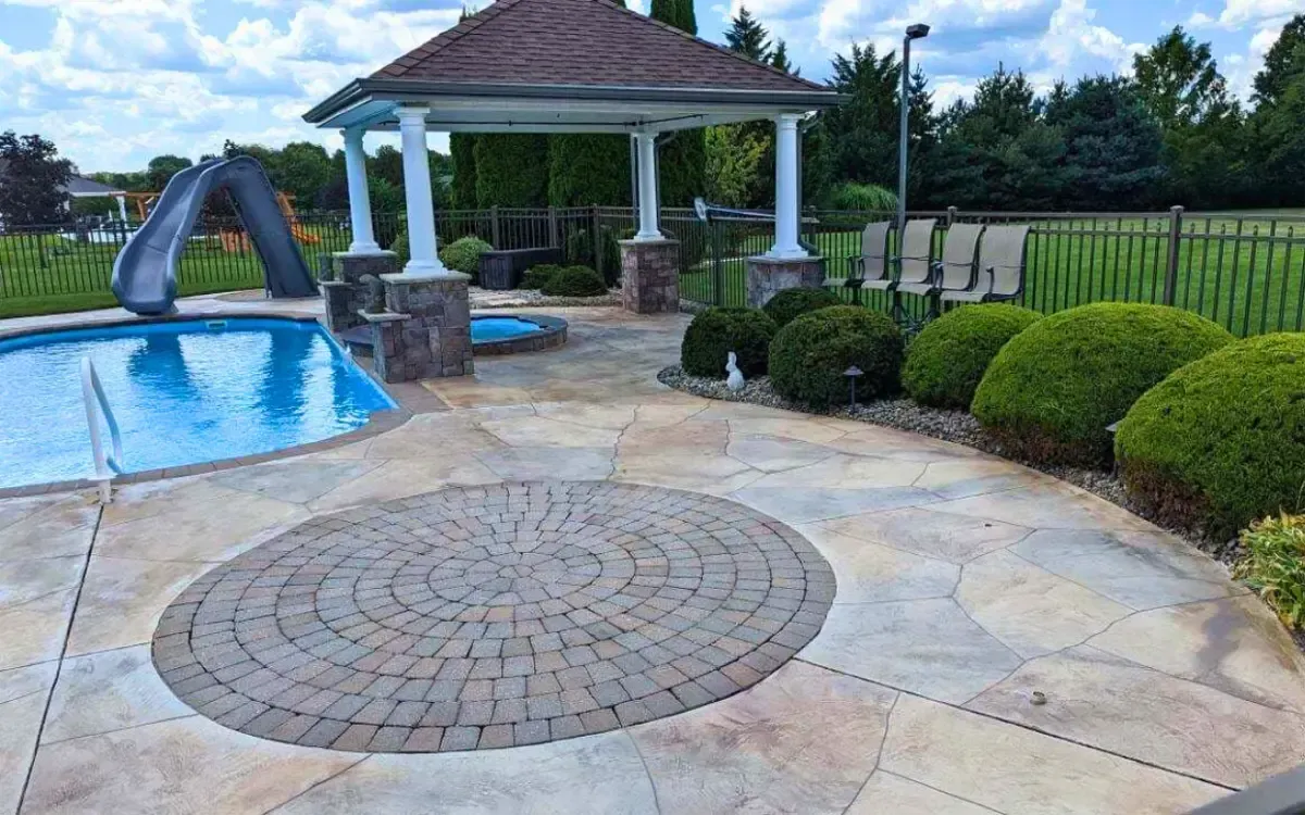 Backyard pool patio with gazebo, lounge chairs, and landscaped garden