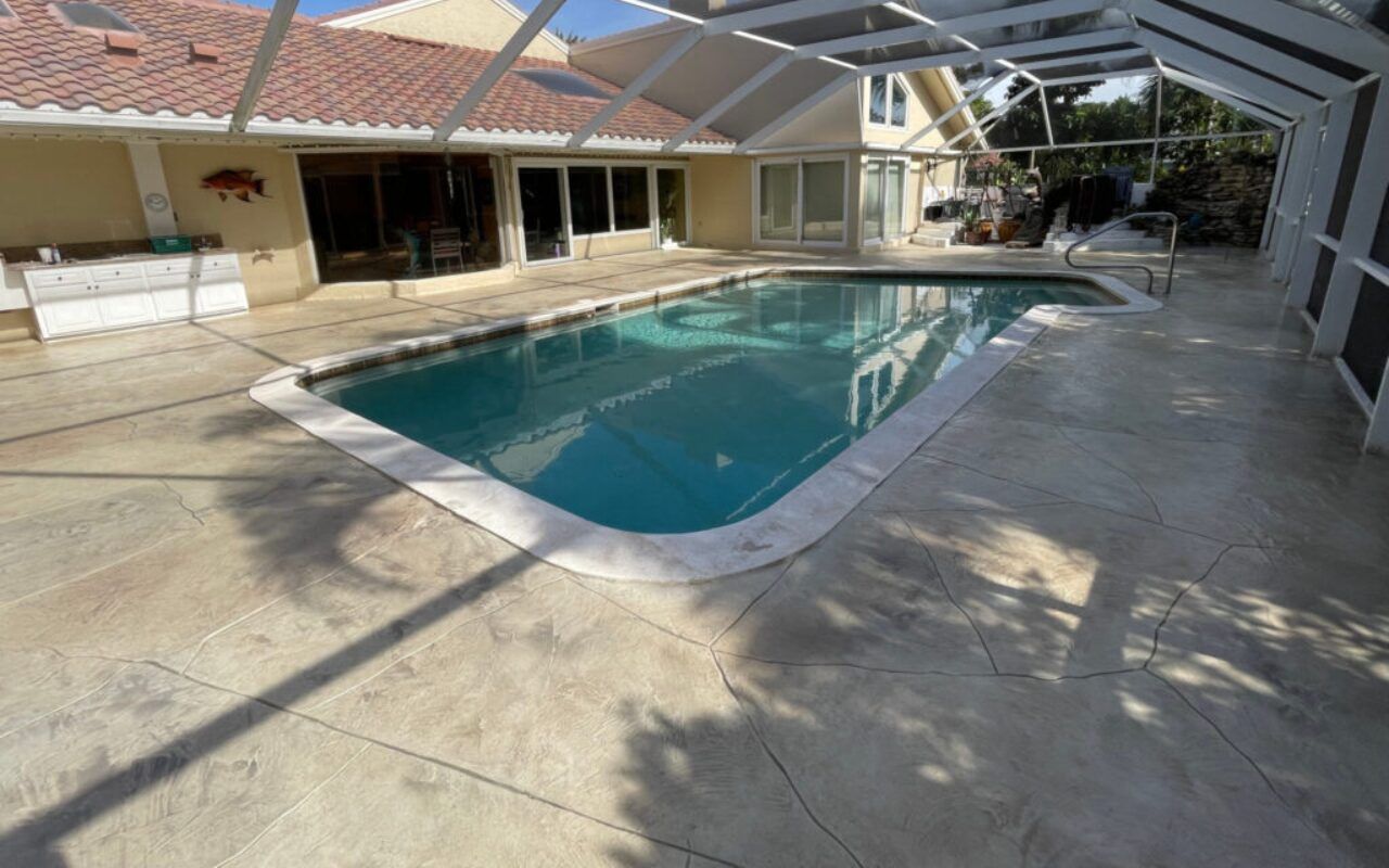 Courtyard with a small turquoise pool beside a tiled patio and house