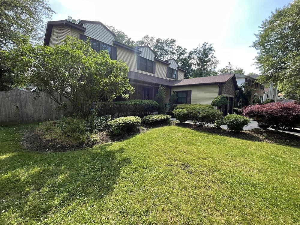 A large house with a large lawn in front of it