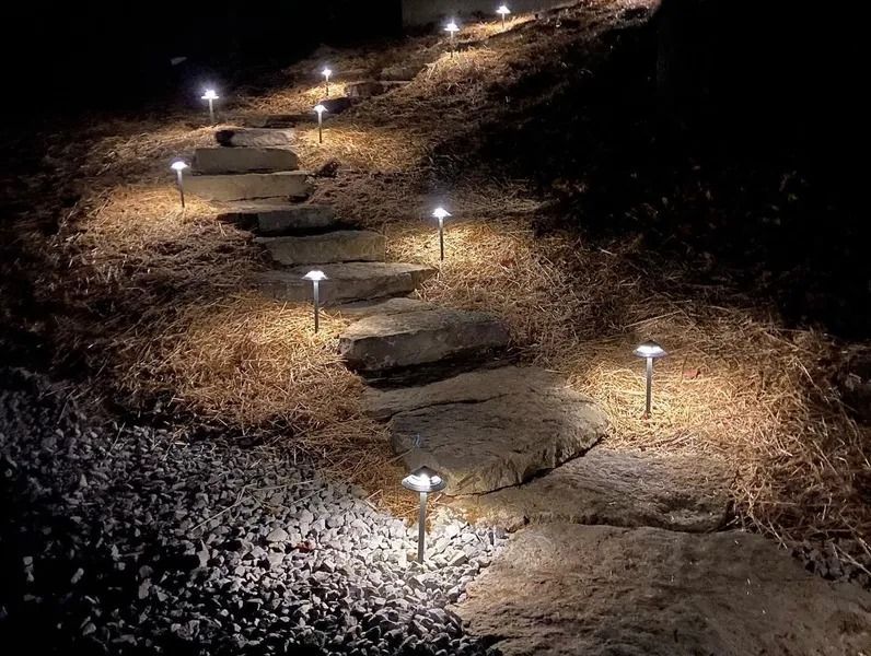 Stone steps illuminated by small lights at night.