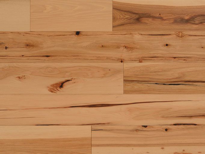 Light brown hardwood flooring with knots and grain.