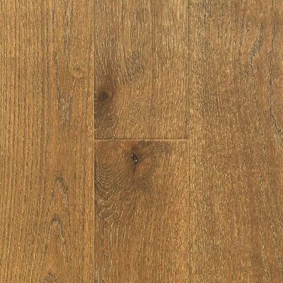 Close-up of weathered brown wood flooring, with visible grain and knots.