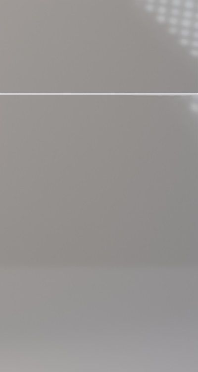 Gray, glossy surface, with a horizontal white line and a patterned shadow in the top right.