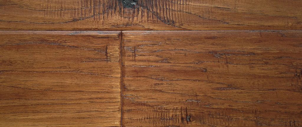 Close-up of brown hardwood flooring with visible wood grain and panel lines.