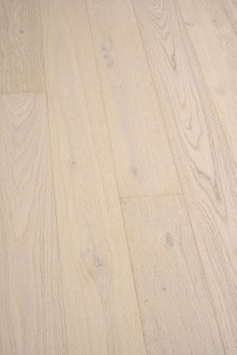 Light-colored hardwood flooring, angled view, with visible wood grain and knots.