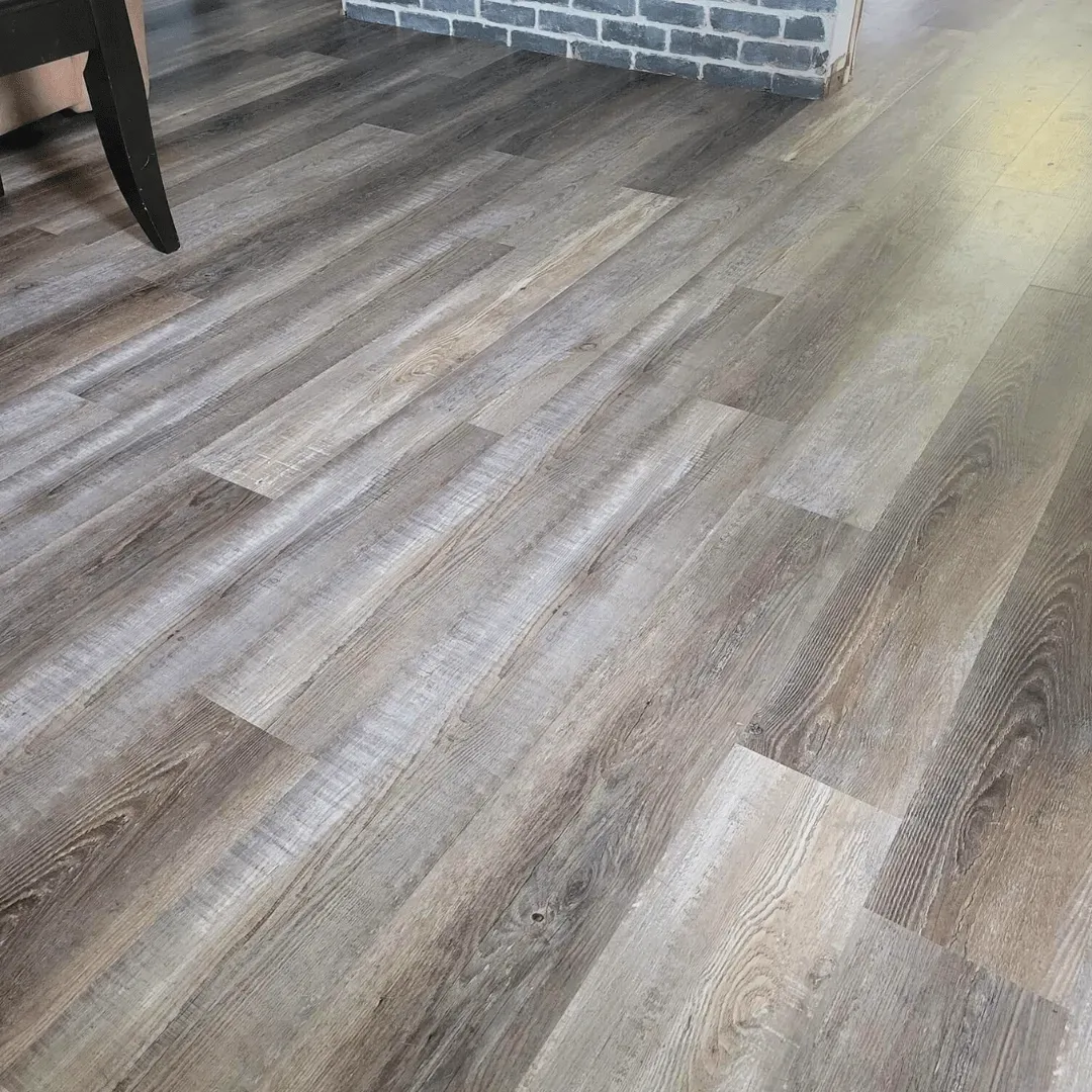Gray and brown wood-look flooring with planks, in a room.