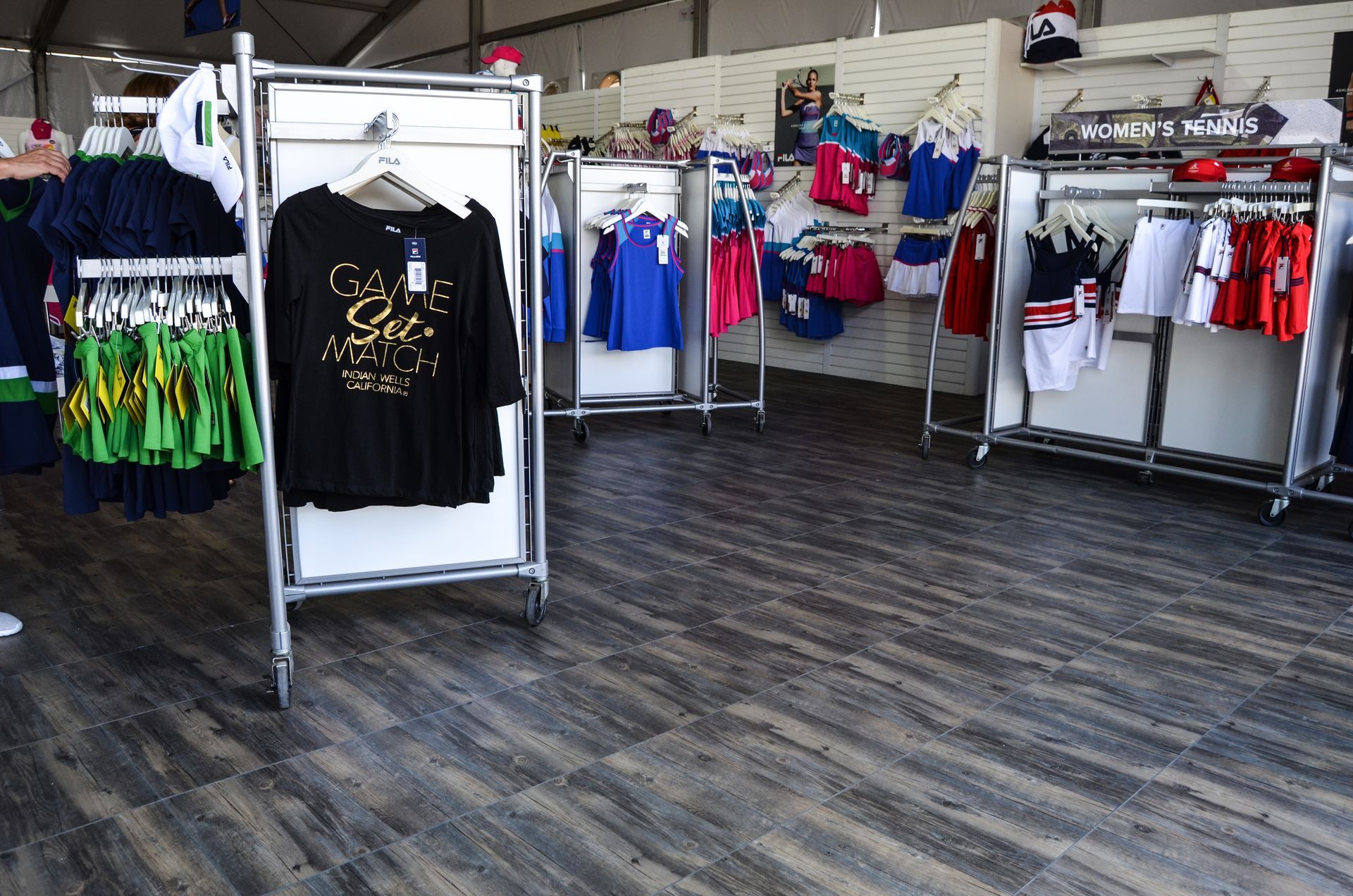Clothing store interior with clothing racks displaying apparel.