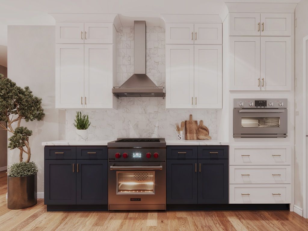 Modern kitchen with white and navy cabinets, stainless steel appliances, and wood flooring.