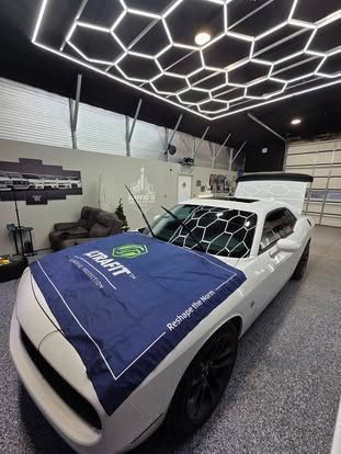 A white sports car with a blue 