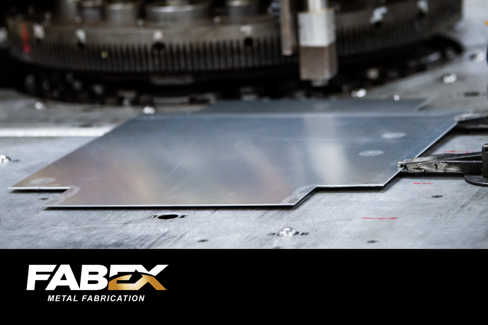 Metal sheet on a fabrication machine with FABEX logo in the corner