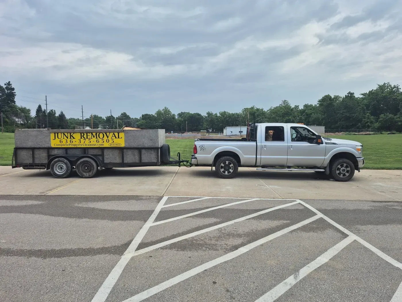 Silver pickup truck towing a trailer with 