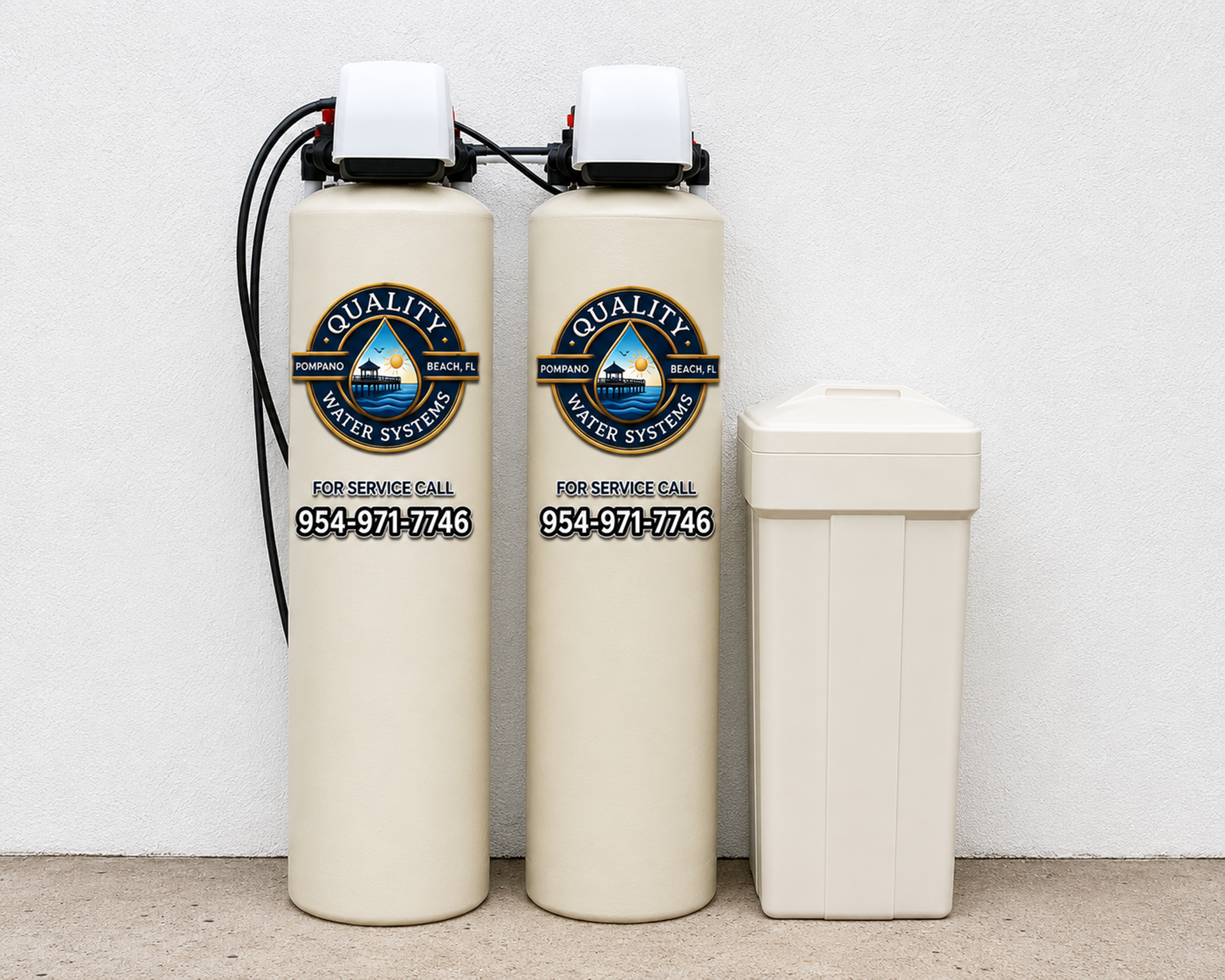 Two beige water softener tanks and a white rectangular bin against a light wall.