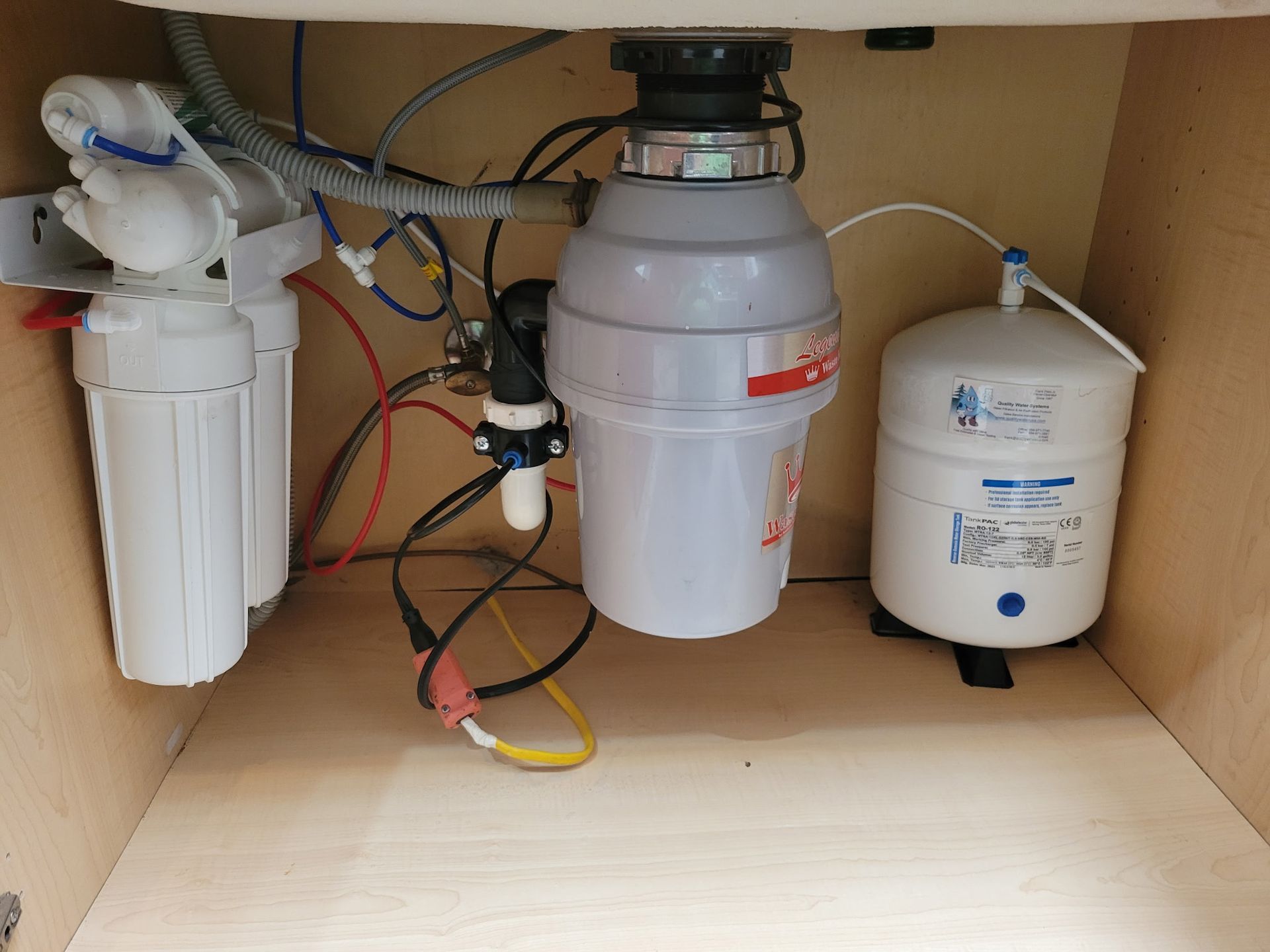 Under-sink reverse osmosis water filter system with white tanks and tubing