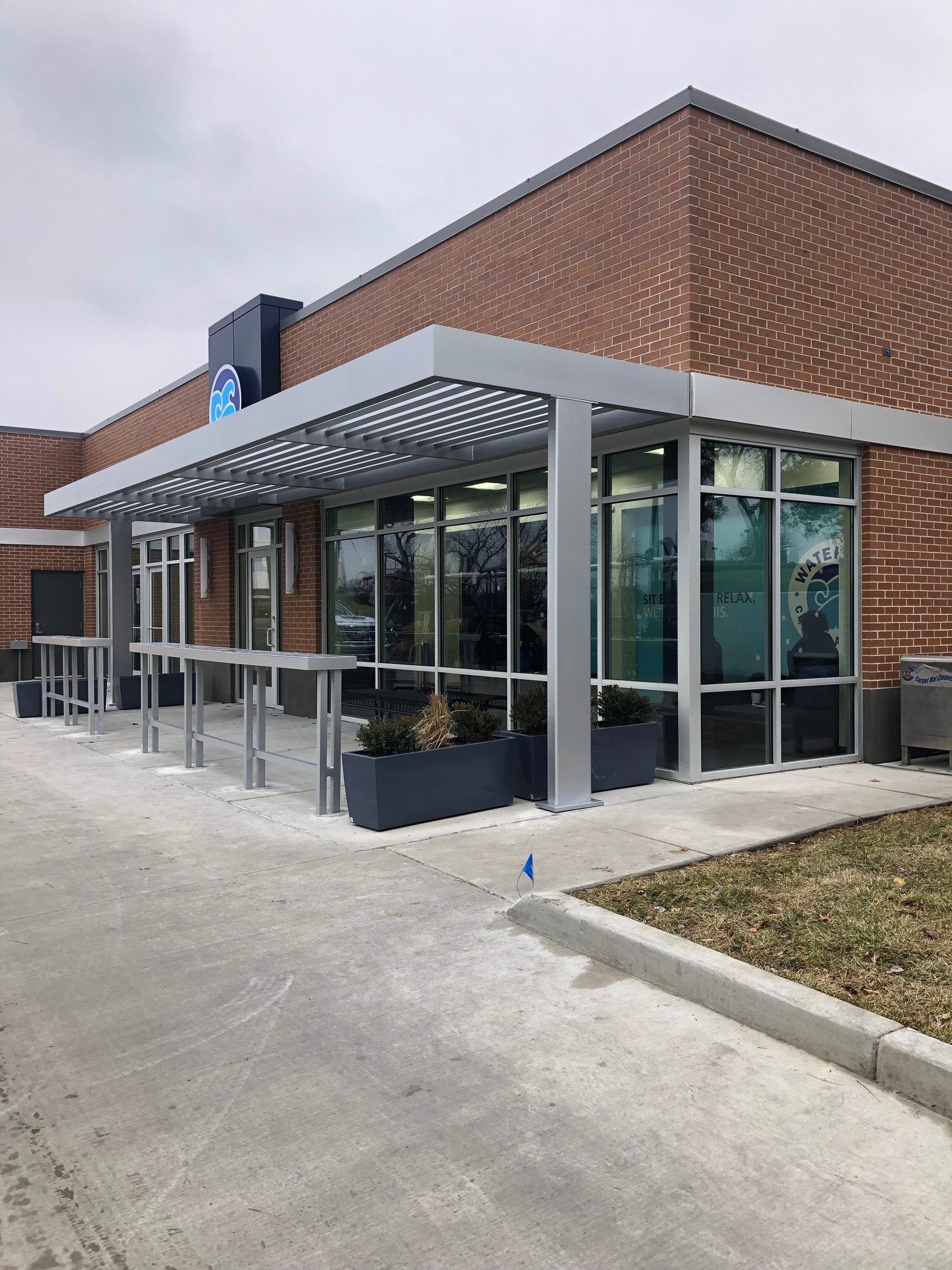 A large brick building with a lot of windows and a canopy over the entrance.