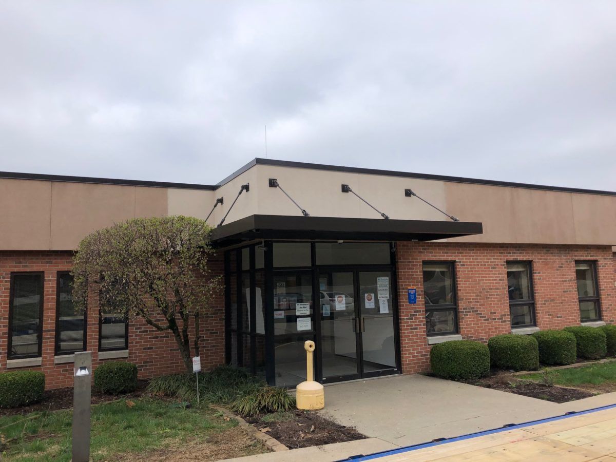 A large brick building with a canopy over the entrance.